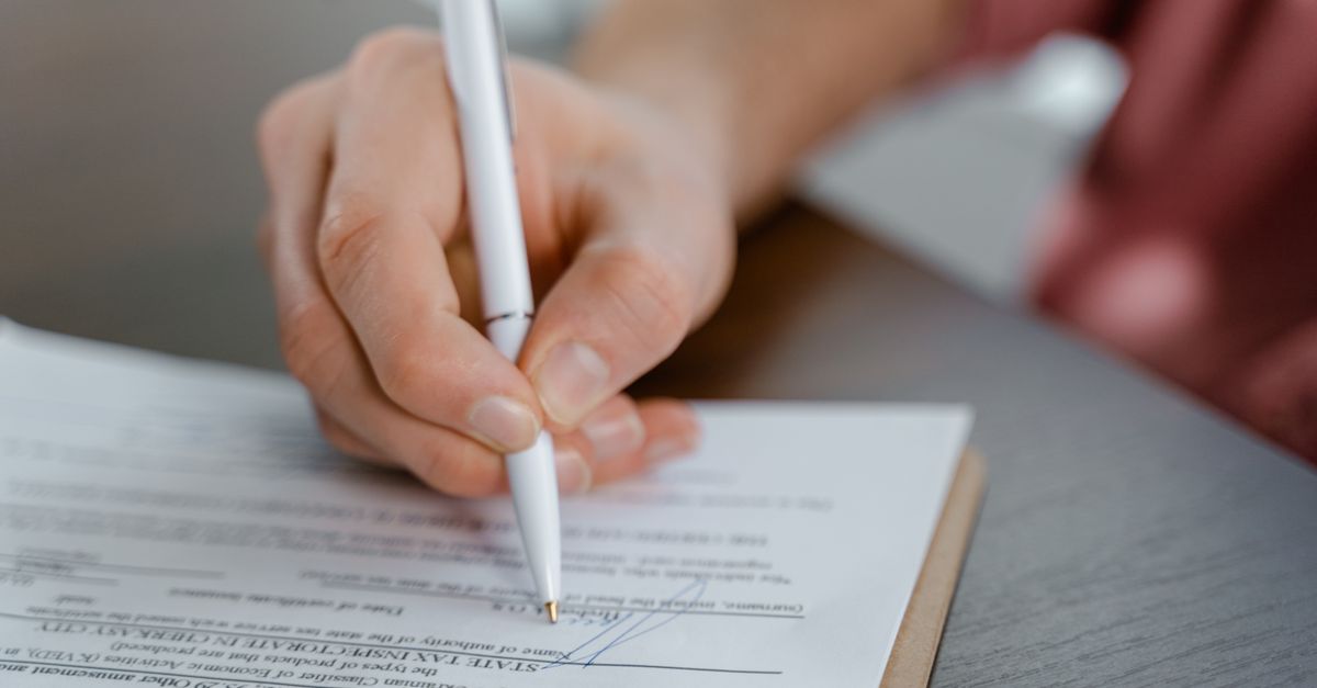 Signing company documents with a pen